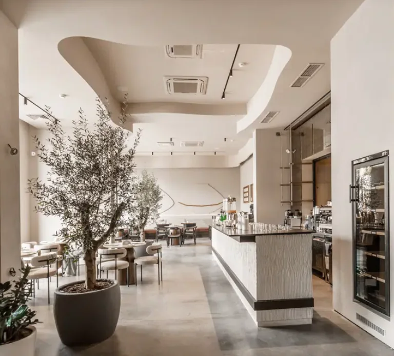 Bright lobby and dining area at Rilas Hotel & Spa